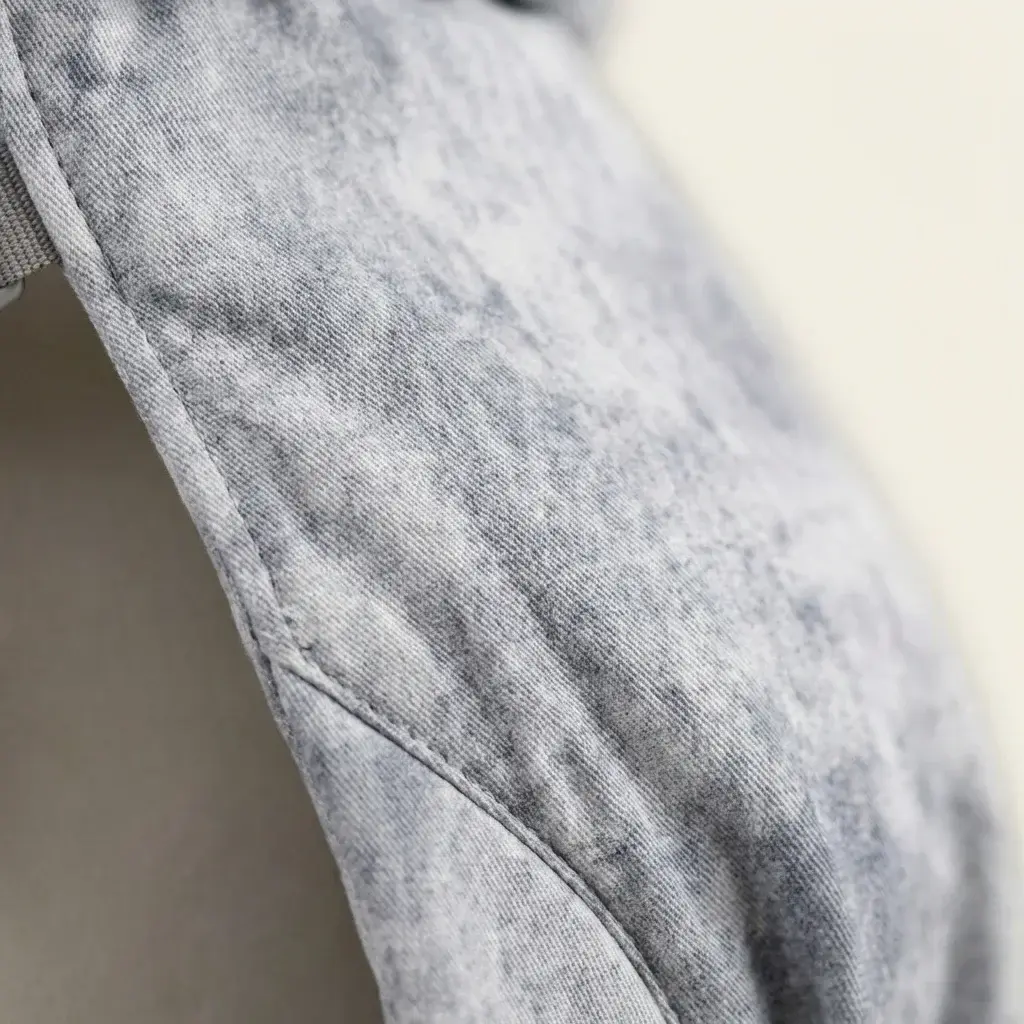 Close-up of the Amari Washed Denim Baby Carrier fabric detail